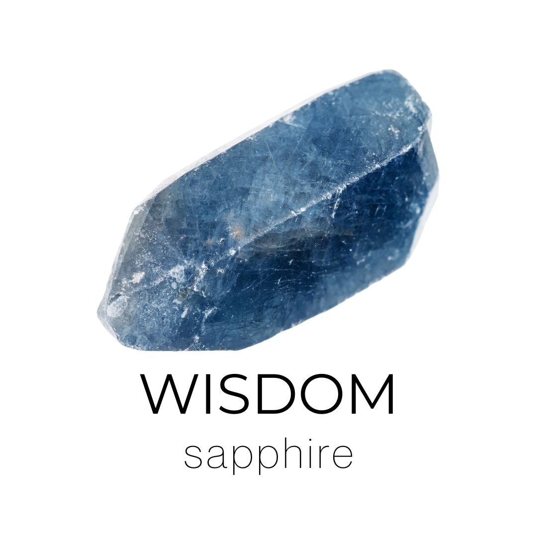Raw sapphire crystal with 'Wisdom' text on a white background