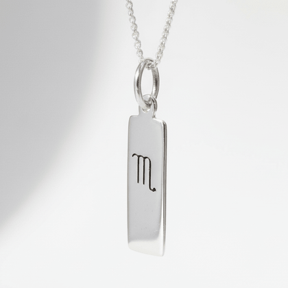 Scorpio Zodiac Necklace in Sterling Silver hanging against a white backgrouned