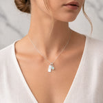 Sterling Silver Necklace with a Scorpio Zodiac Pendant and a tear drop shaped October Birthstone Opal Pendant being worn