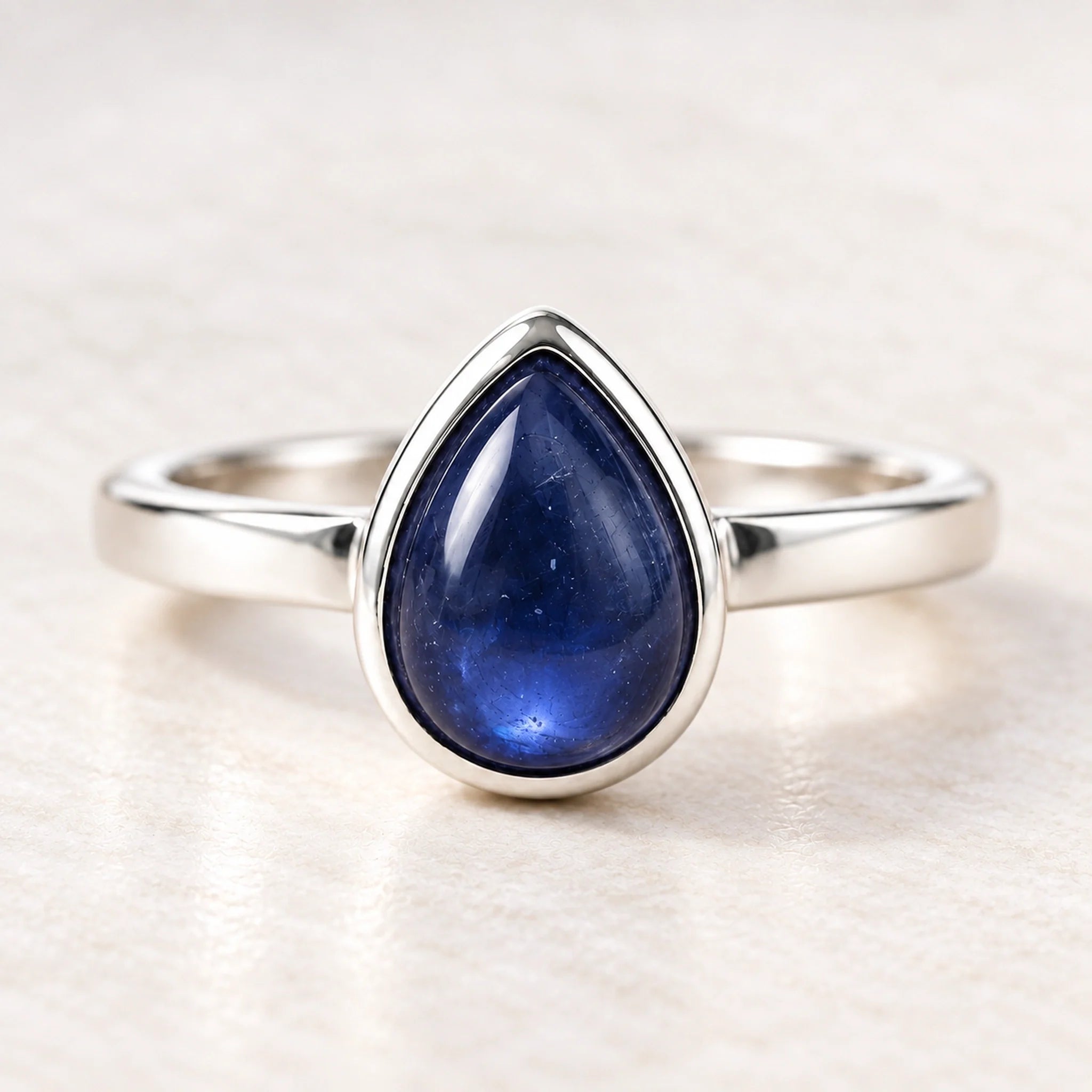 Sterling silver September birthstone natural sapphire ring on a matte white surface