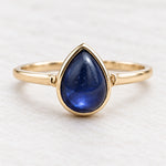 Gold September sapphire birthstone ring with a natural pear-shaped stone