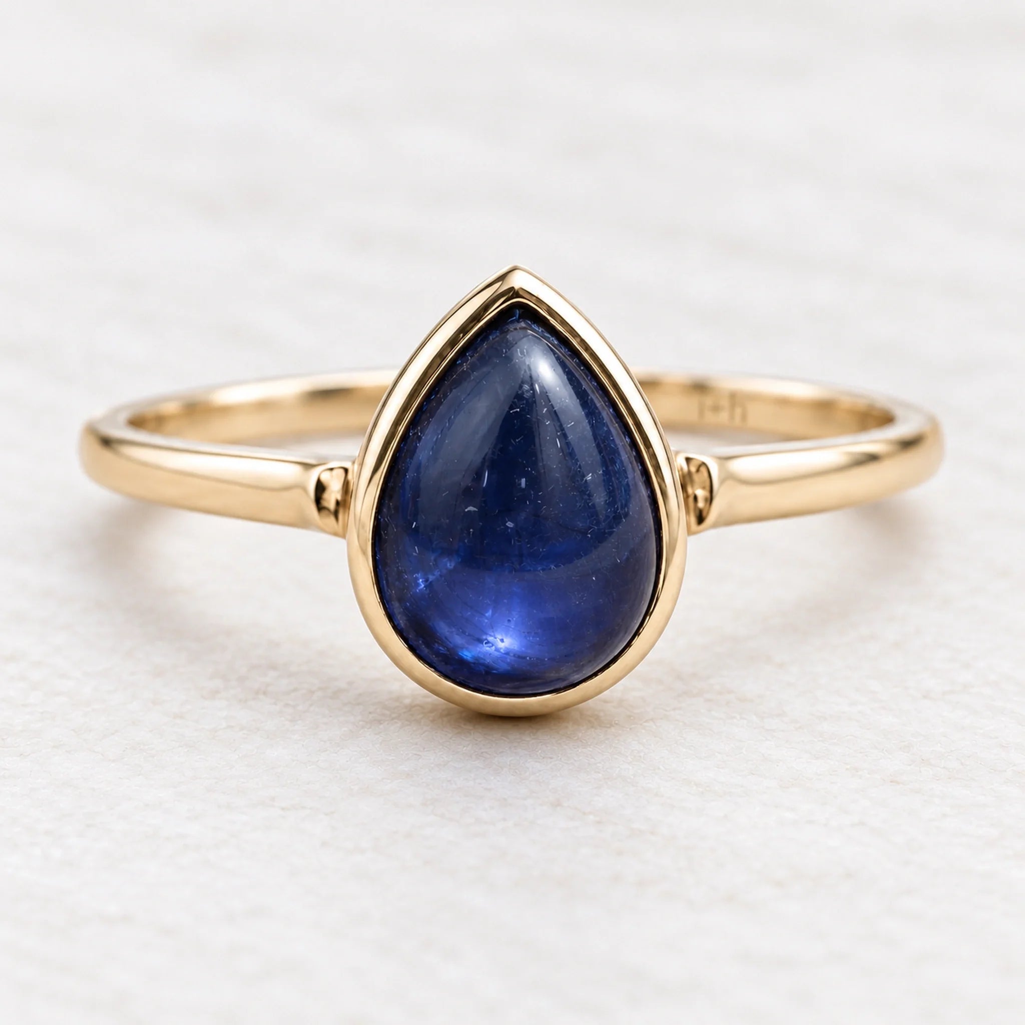 Gold September sapphire birthstone ring with a natural pear-shaped stone