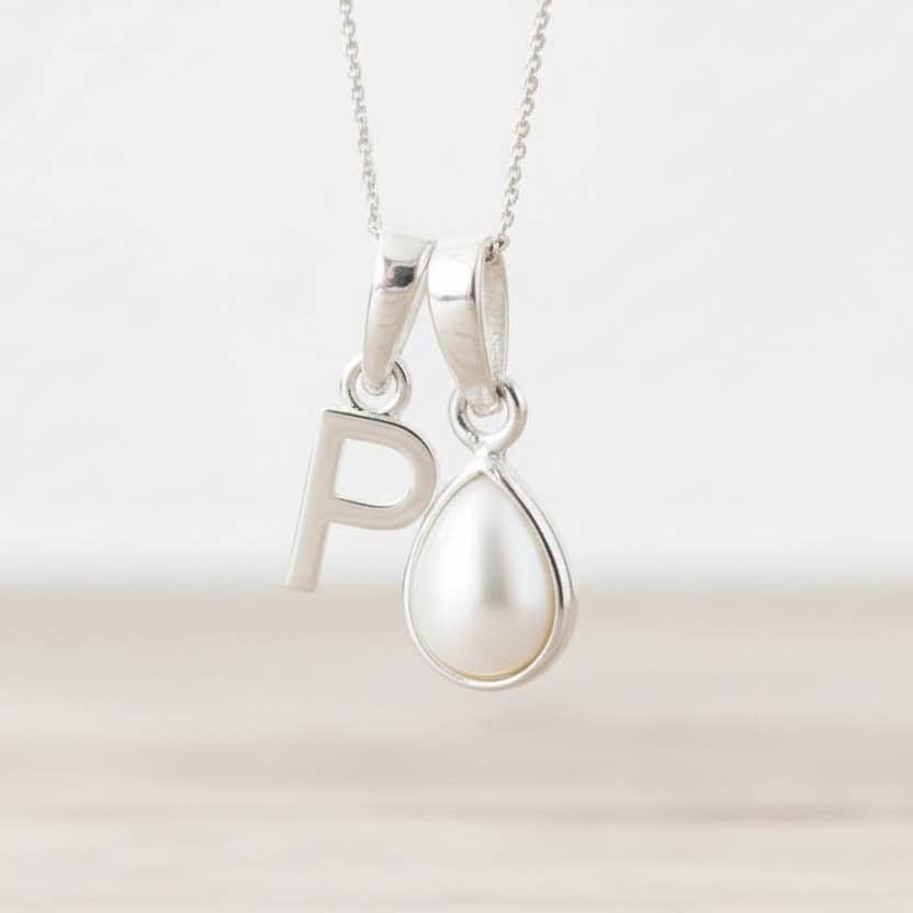 Sterling Silver necklace with 'P' initial pendant together with a tear drop pearl pendant on a white background