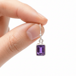 silver amethyst earrings being held