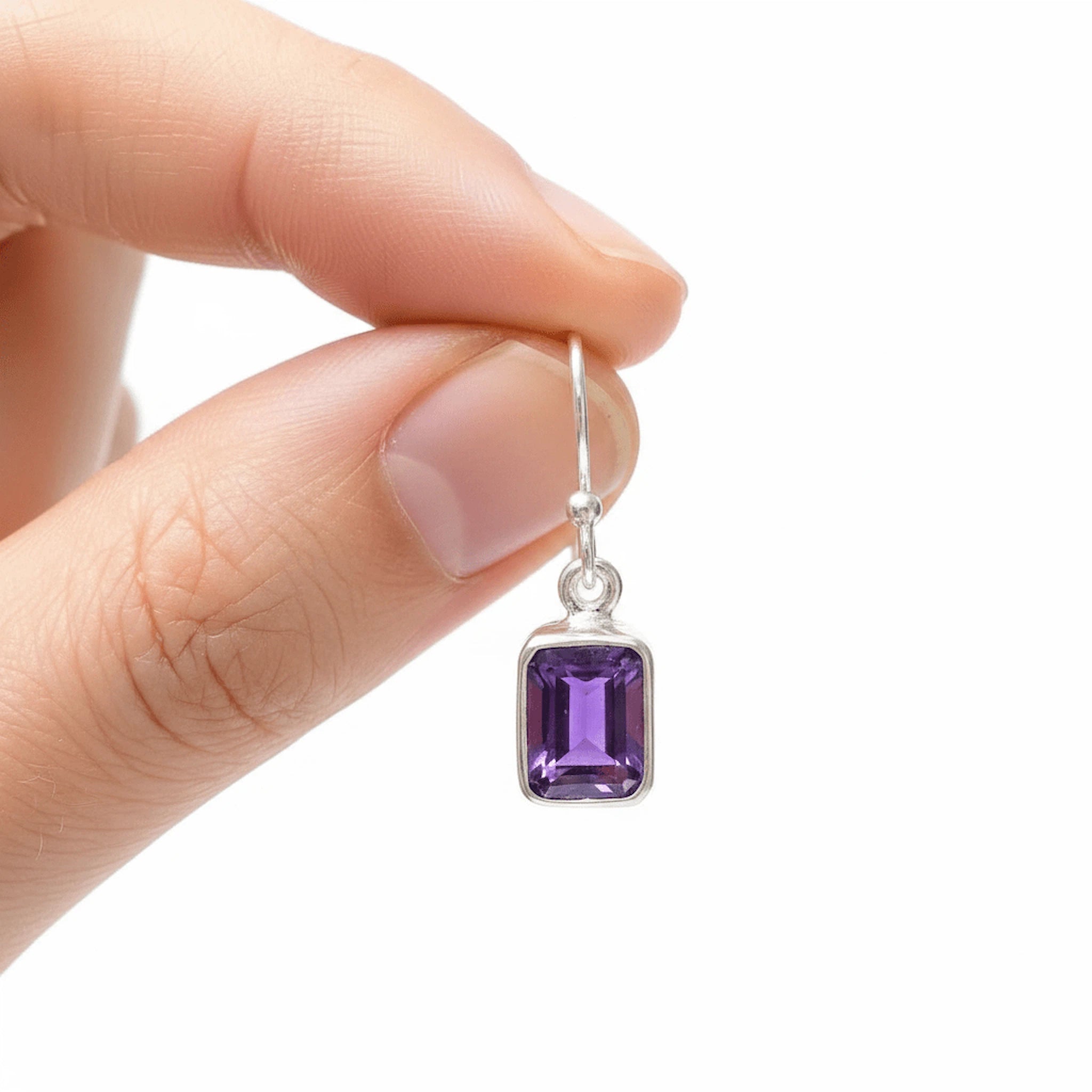 sterling silver natural amethyst earrings being held