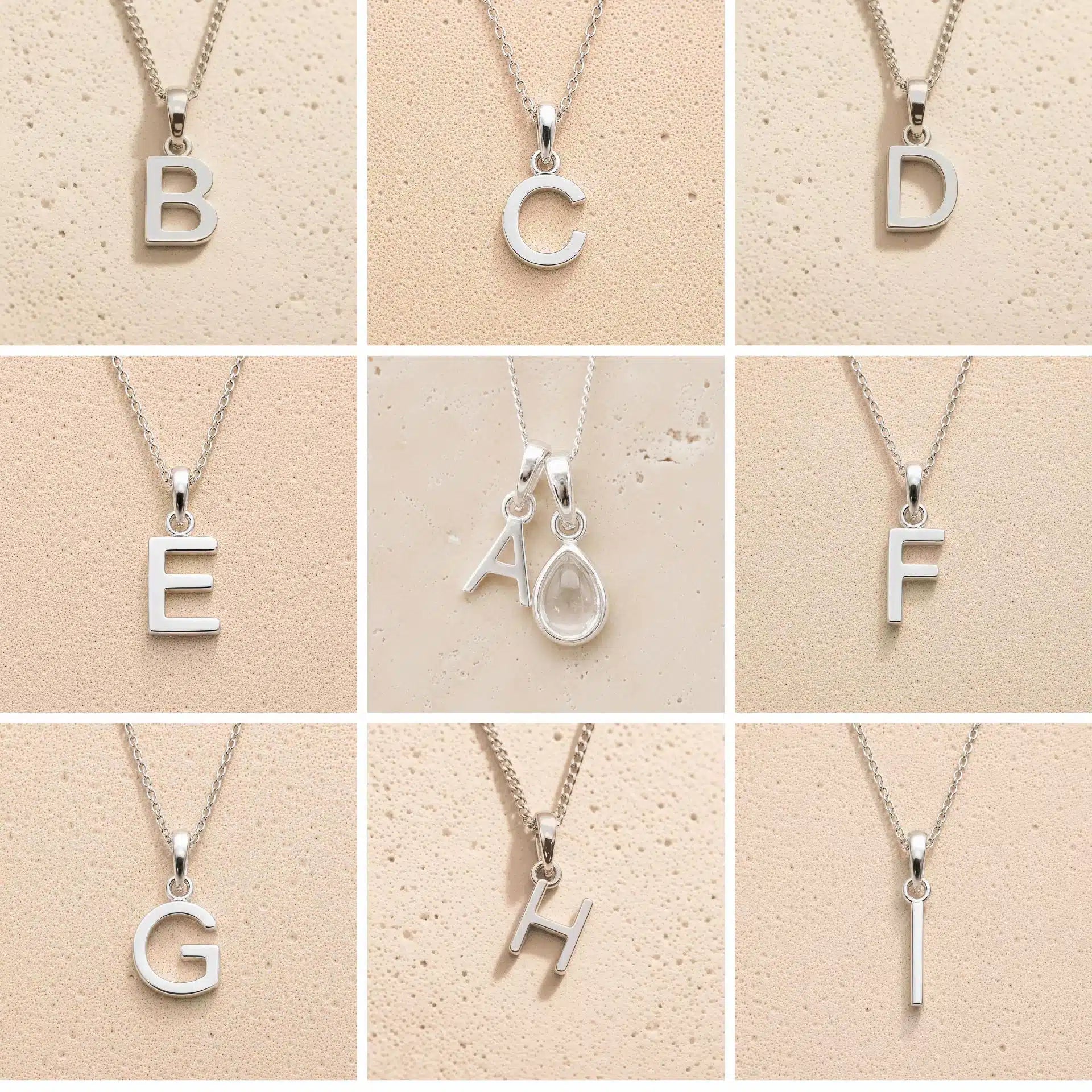 Collection of silver letter necklaces A to I on a beige background as initial options for a personalised April Birthstone Clear Quartz Necklace.