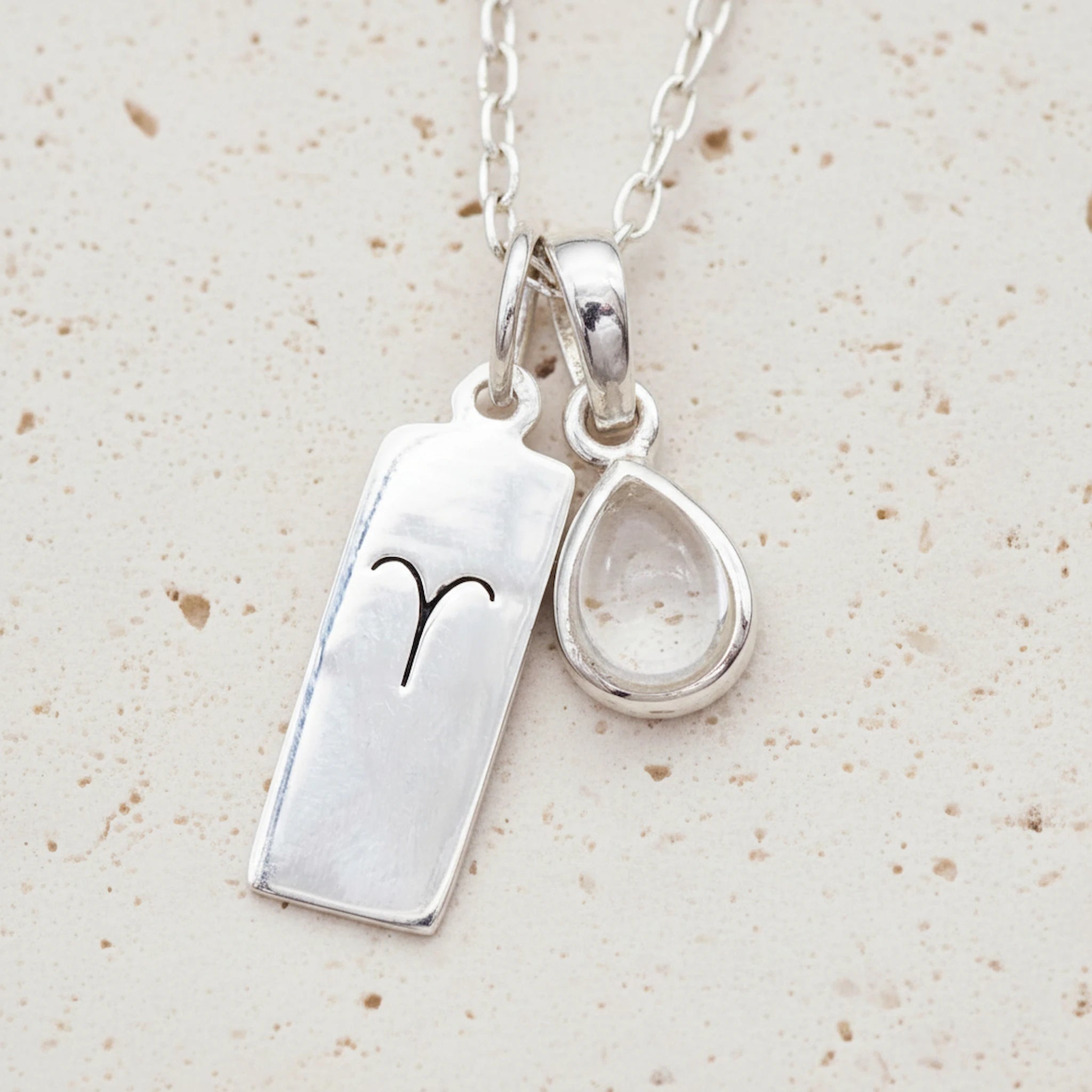 Sterling Silver April Birthstone necklace with a pear-shaped natural Herkimer Quartz pendant and a Aries zodiac pendant