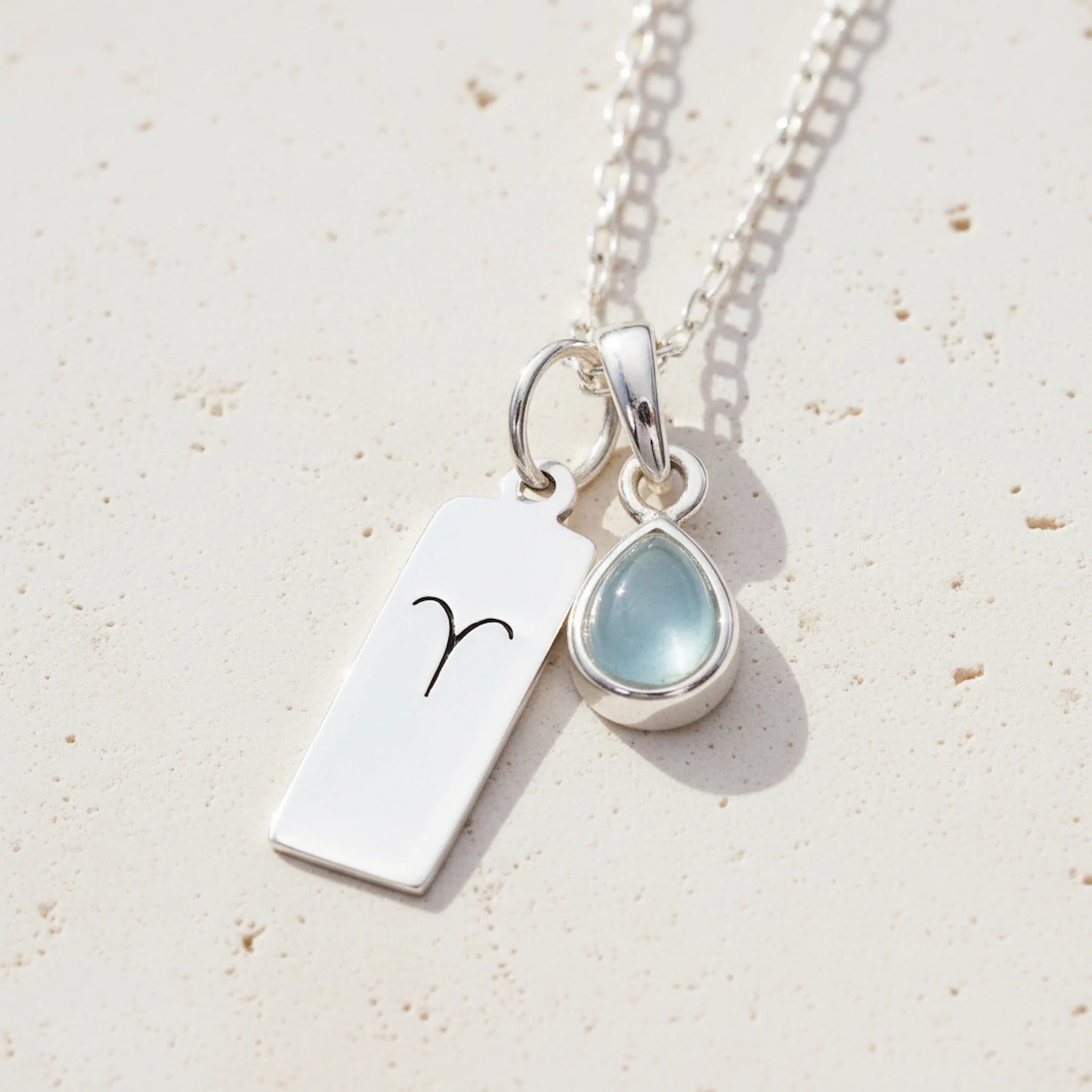Sterling Silver March Birthstone Necklace with a pear-shaped natural Aquamarine gemstone pendant and Aries Zodiac pendant