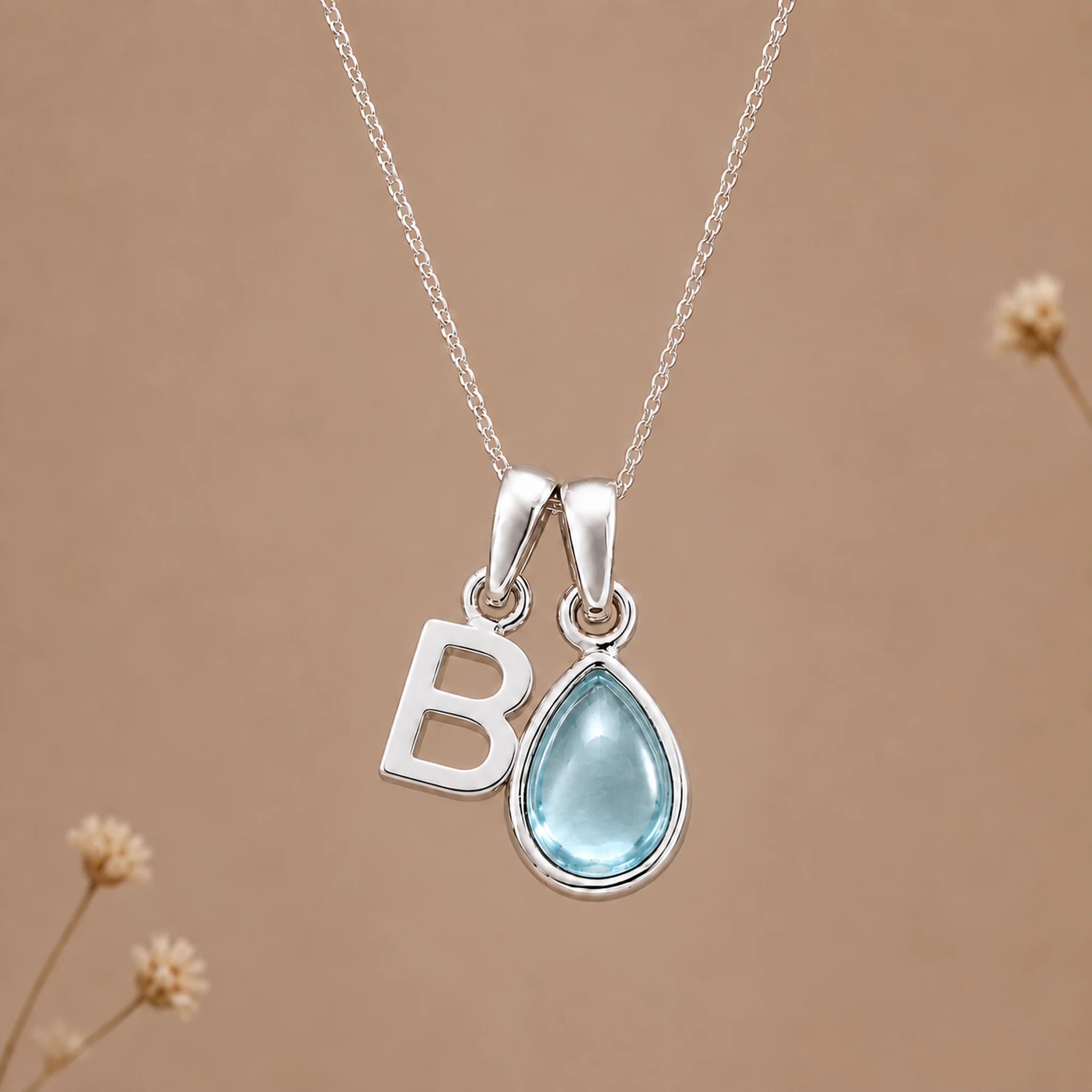 Sterling silver B initial necklace with pale blue March aquamarine in a polished teardrop bezel