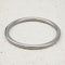 Silver bangle on a beige textured surface