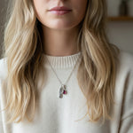 Sterling Silver July Birthstone necklace with a pear-shaped natural Ruby pendant and a Cancer zodiac pendant being worn