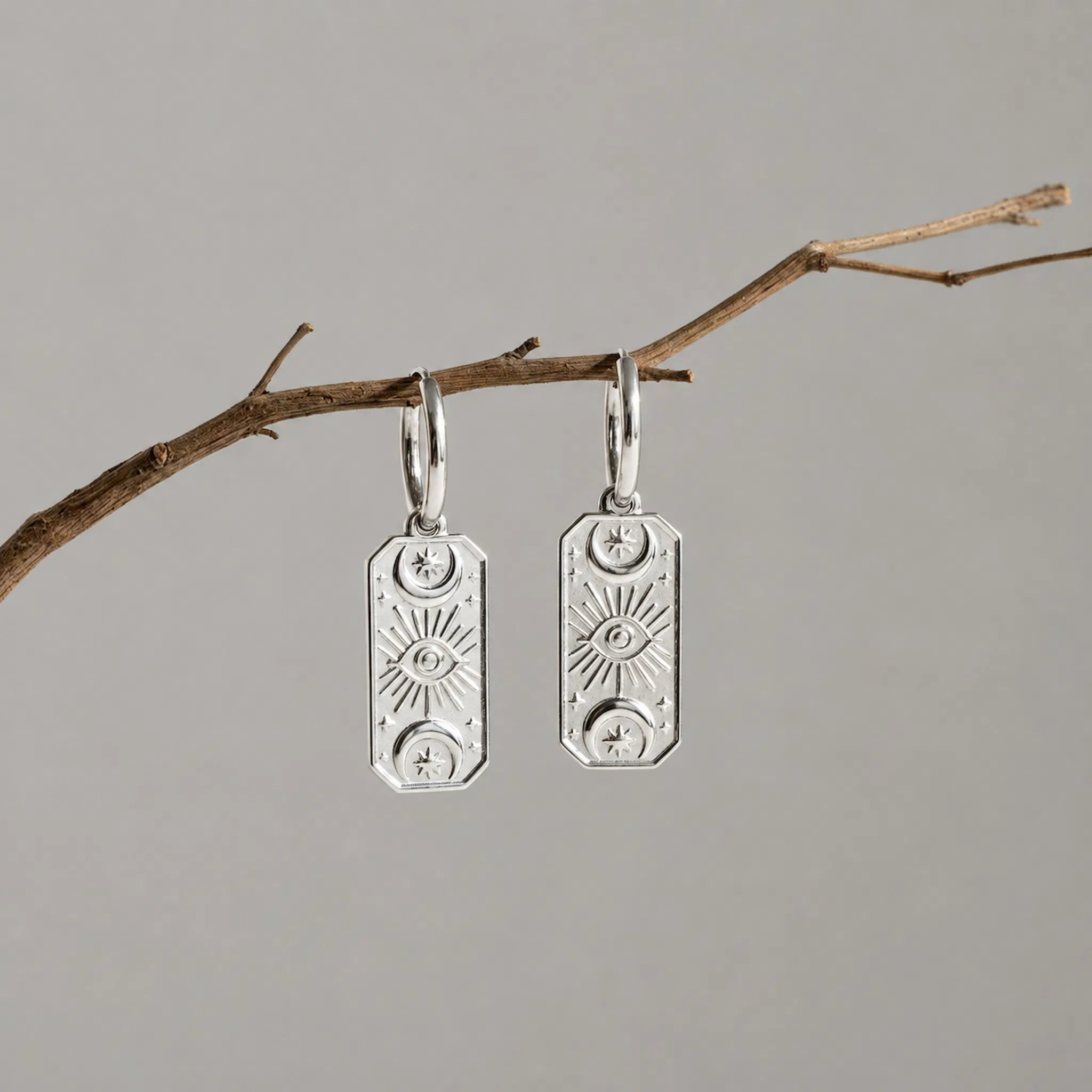 Indie and Harper Silver Celestial Charm Huggie Hoop Earrings pair.