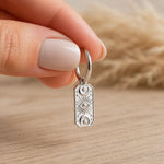 one silver celestial charm hoop earring held