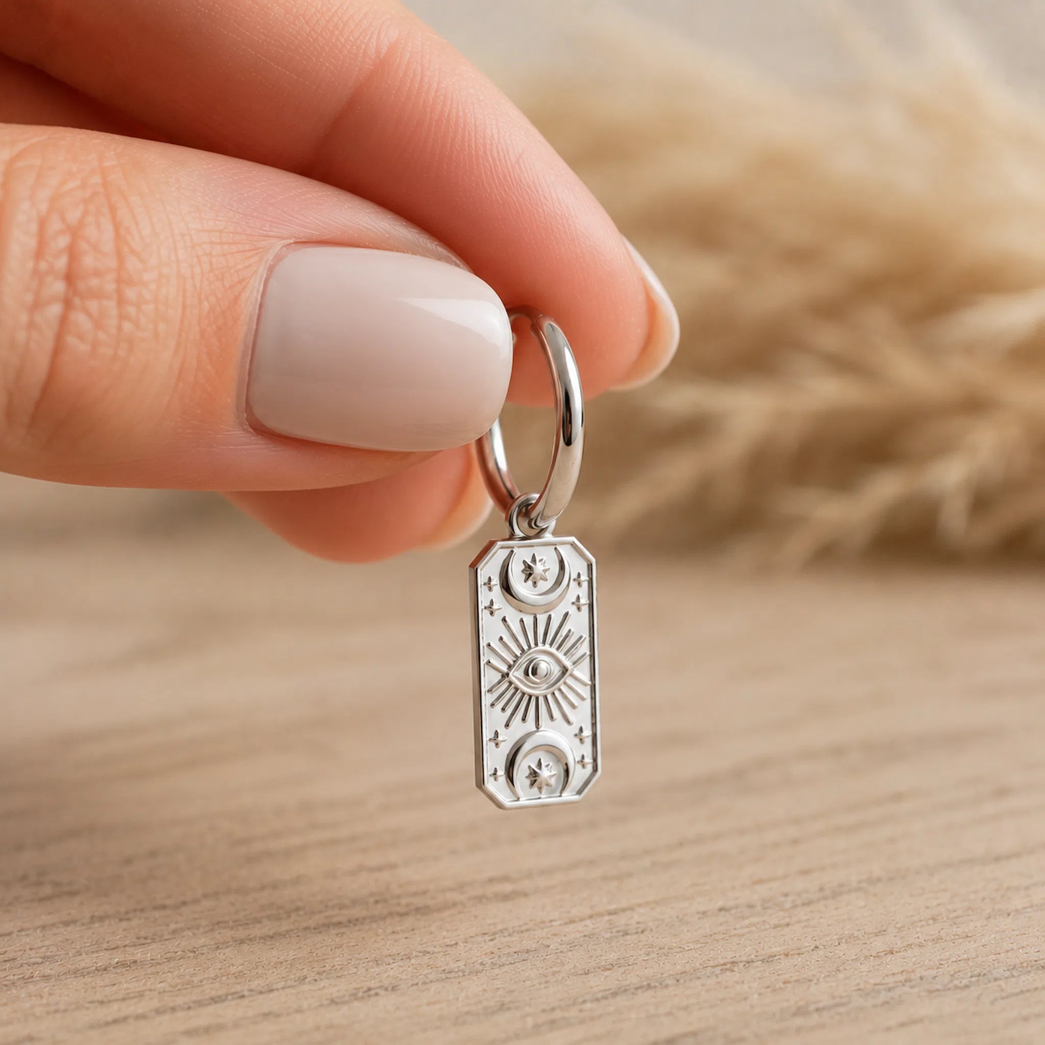 one silver celestial charm hoop earring held