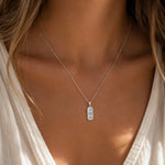 model wearing a silver celestial charm pendant necklace