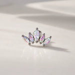 Silver earring with iridescent gemstones on a light background