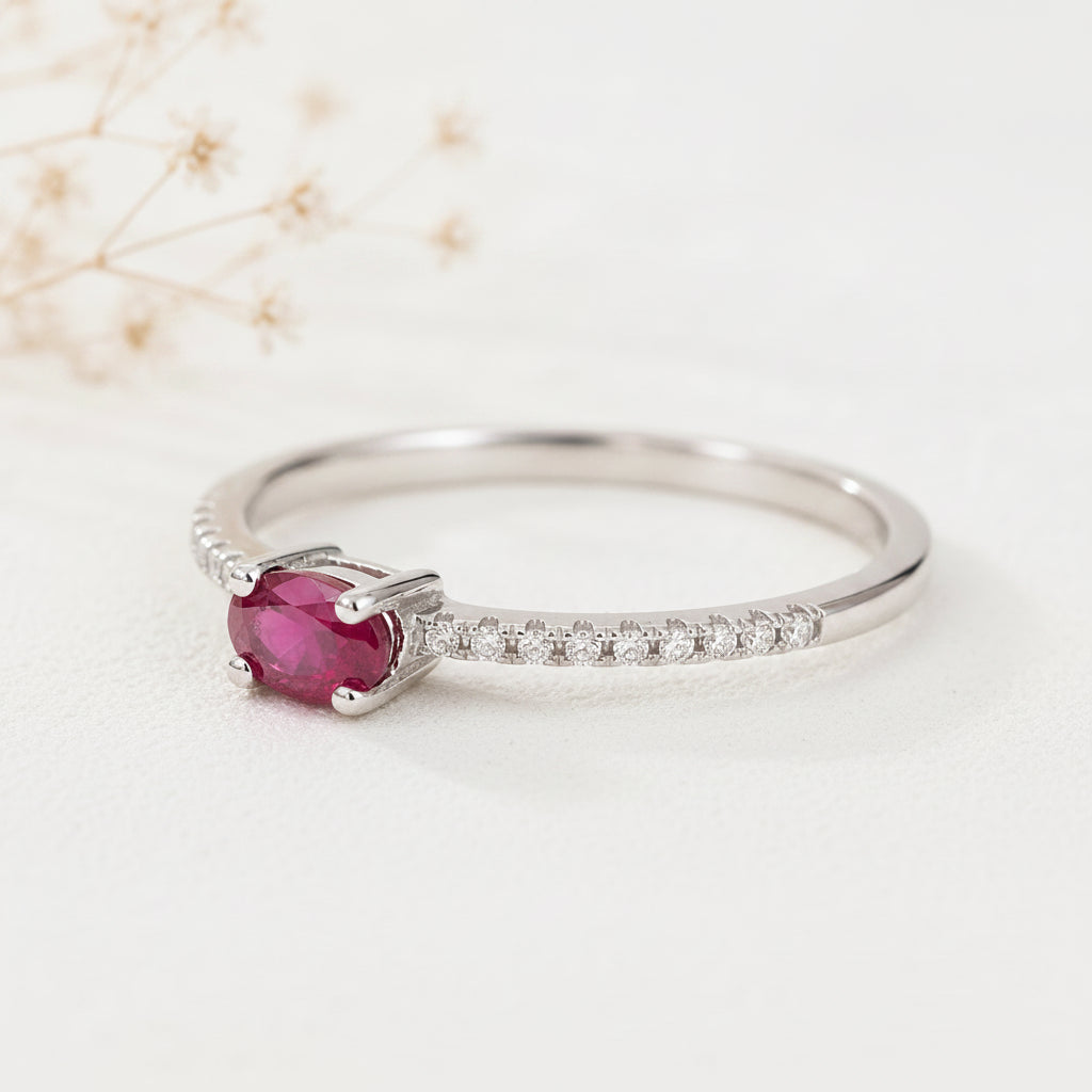 sterling Silver ruby ring with CZ pave style band with a natural red ruby centre gemstone on a beige background
