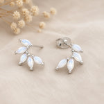 pair of sterling silver stud earrings with marquise shaped czs on a light surface