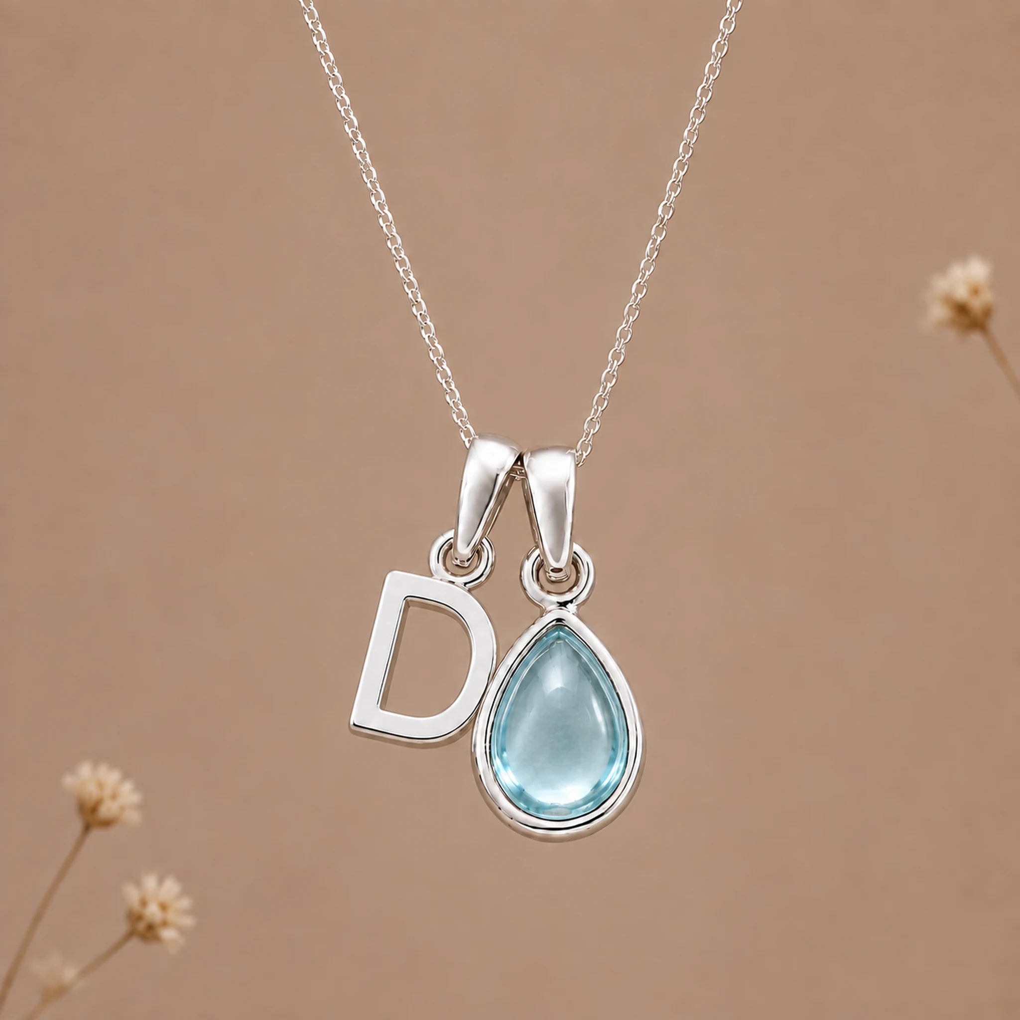 Sterling silver D initial necklace with pale blue March aquamarine in a polished teardrop bezel