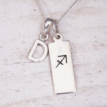 sterling silver necklace with a 'D' initial pendant and a sagittarius zodiac pendant on a light background