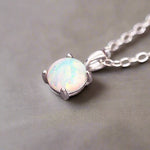 Opal pendant necklace on a gray background