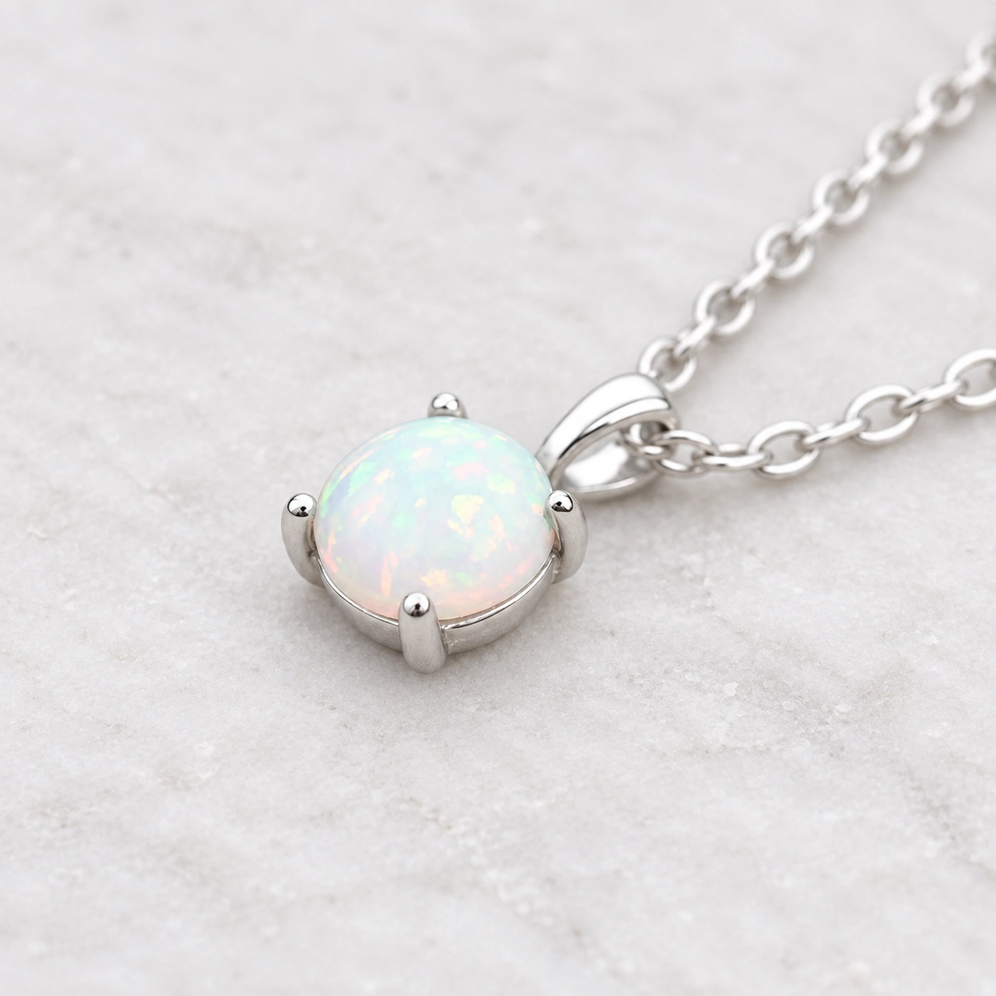 sterling silver white Opal pendant necklace on a wooden background