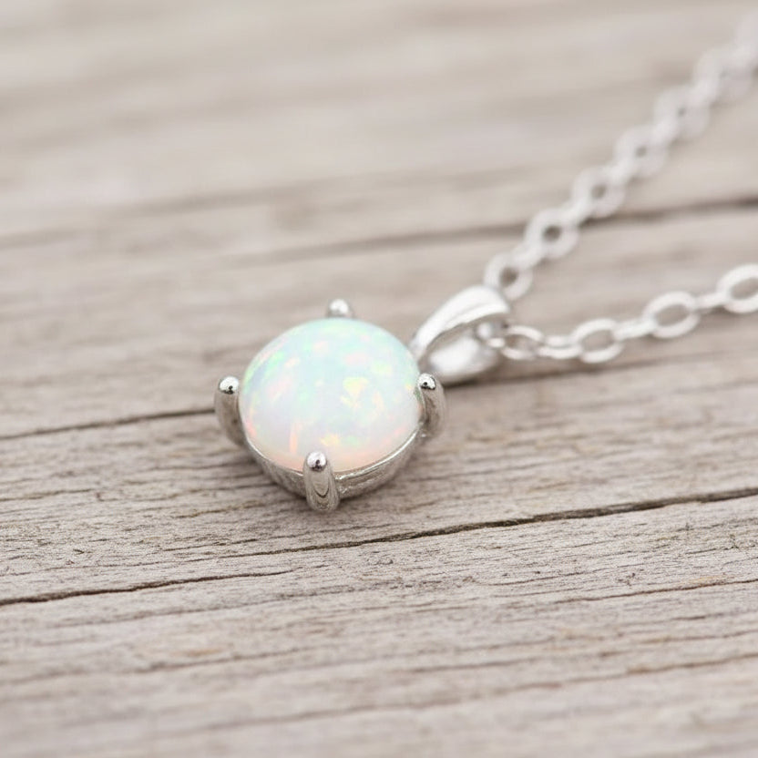 Opal pendant necklace on a gray background
