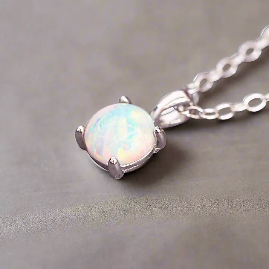 Opal pendant necklace on a gray background