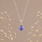 December birthstone tanzanite necklace by Indie and Harper with a purple teardrop pendant on a silver chain