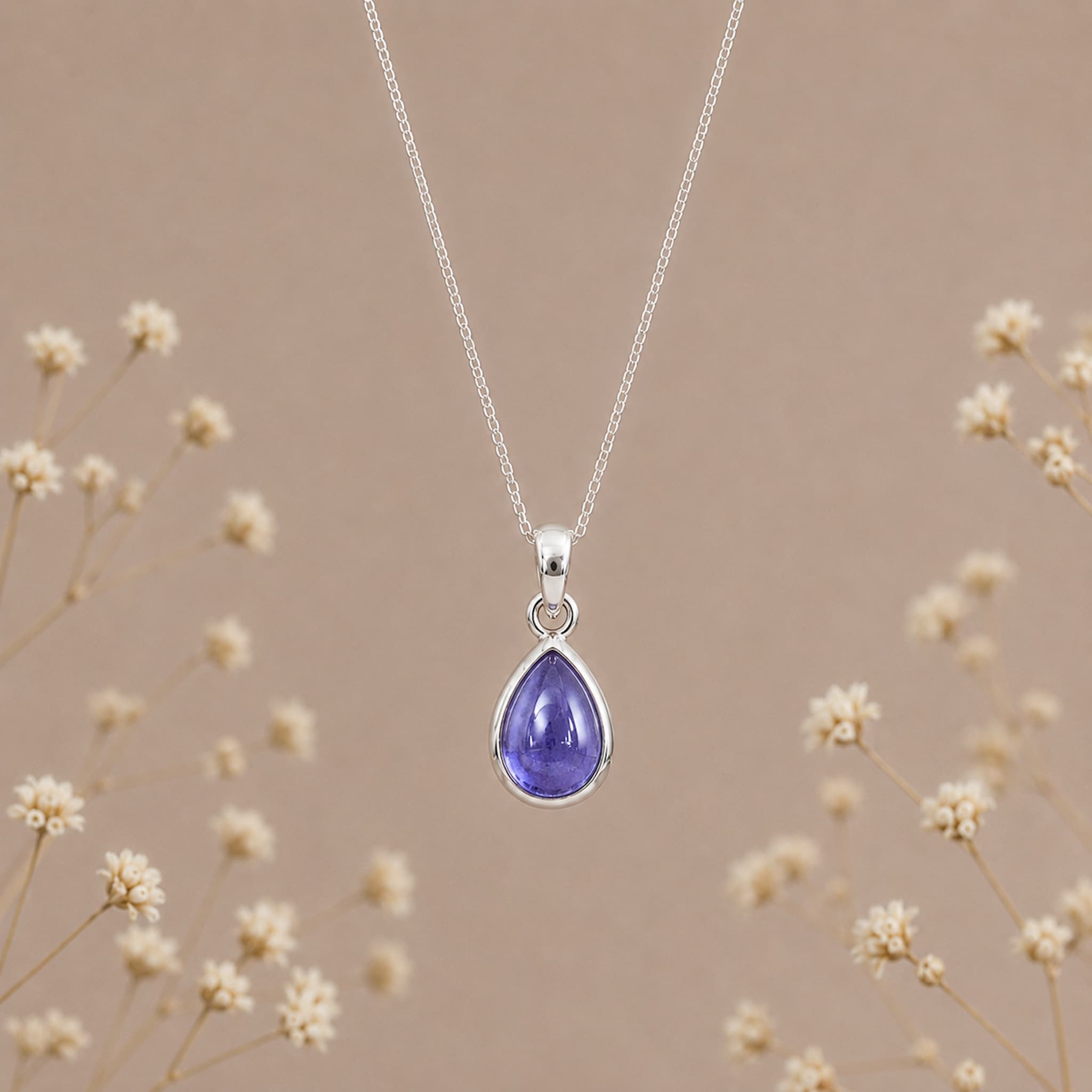 December birthstone tanzanite necklace by Indie and Harper with a purple teardrop pendant on a silver chain
