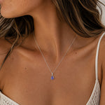 December birthstone Tanzanite necklace with silver chain and purple teardrop pendant by Indie and Harper