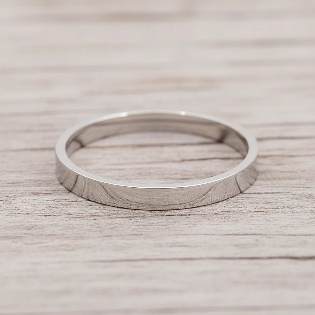 Silver band ring on a wooden surface