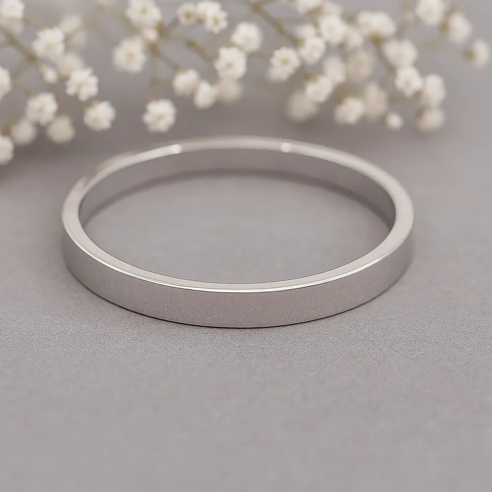 silver band ring on grey surface - silver waterproof jewellery australia by indie and harper