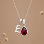 Sterling silver initial E necklace with a natural January garnet