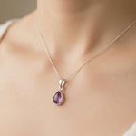 Sterling silver necklace with tear drop amethyst gemstone being worn