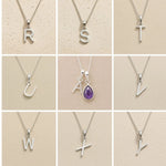 Collection of silver necklaces with initial pendant R to Y on a beige background as personalised letter options to add to a February Birthstone Amethyst Necklace.