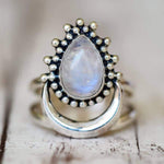 sterling Silver moonstone ring with a teardrop-shaped moonstone gemstone on a wooden surface 