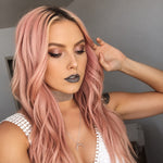 Woman with pink hair and dark lipstick posing indoors wearing a silver crescent moon necklace