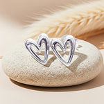Silver heart-shaped ring on a stone with a soft focus background
