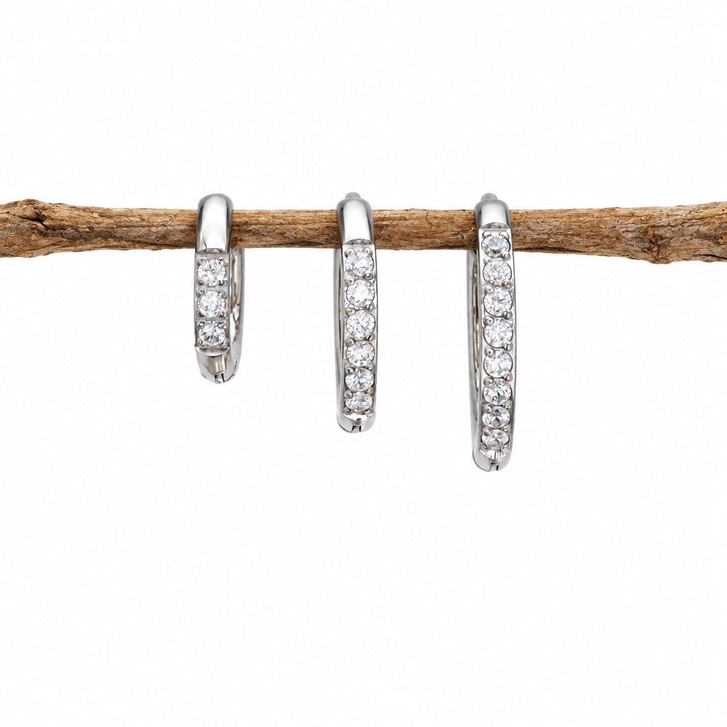 Three silver waterproof pavé huggie hoop earrings in three sizes