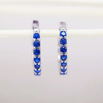 Sterling Silver huggie earrings with blue cubic zirconias