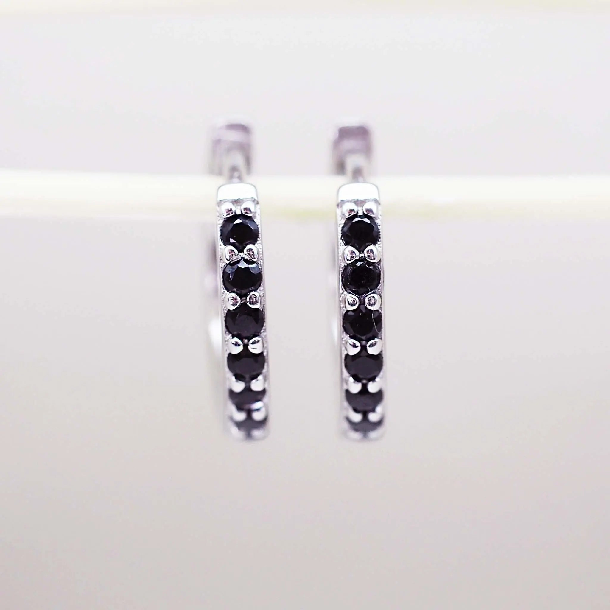 Sterling Silver dainty silver huggie earrings with black cubic zirconias