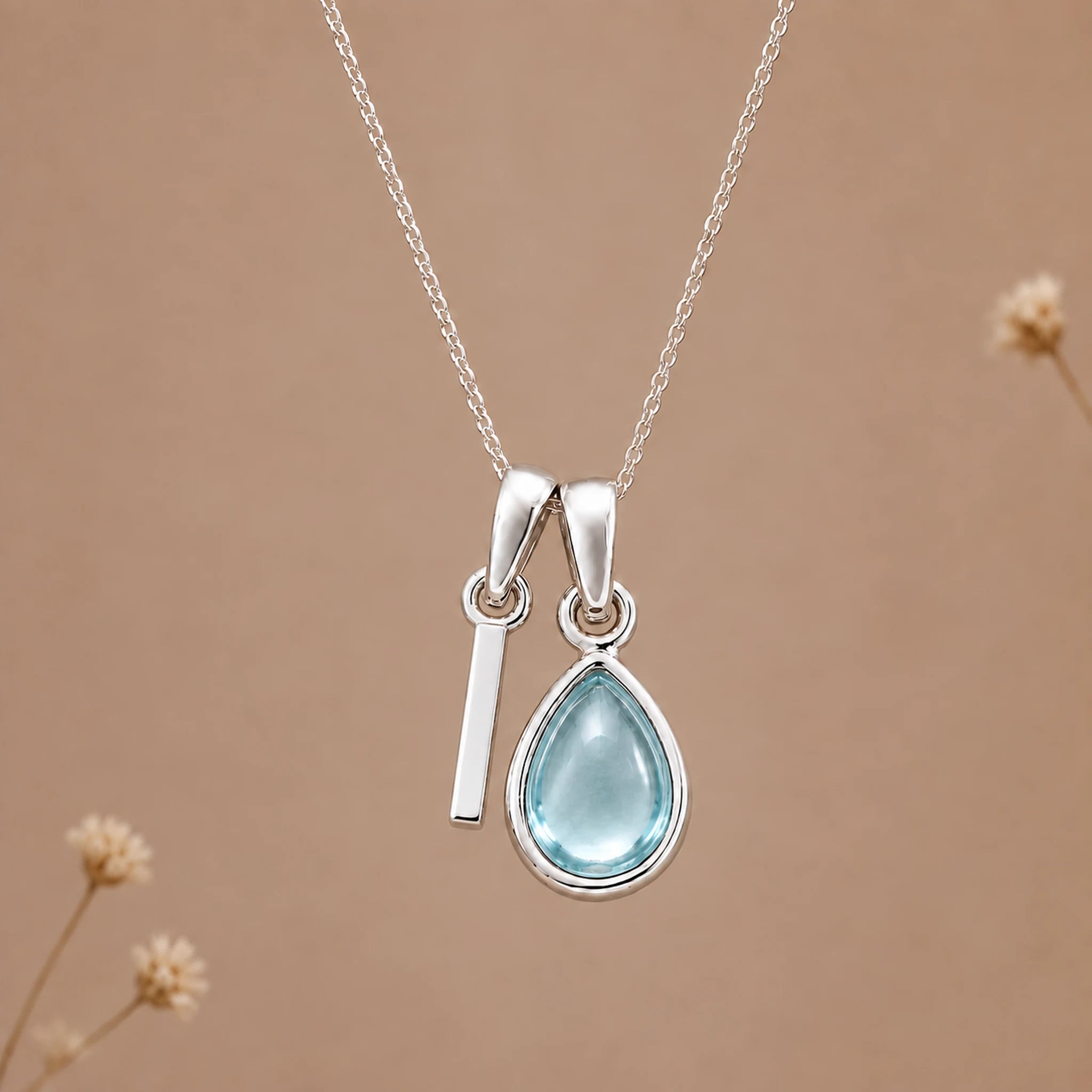 Sterling silver I initial necklace with pale blue March aquamarine in a polished teardrop bezel