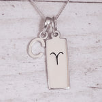 Sterling Silver necklace with a 'C' initial pendant and a Aries Zodiac pendant on a light grey background.