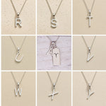 Collage of silver necklaces with letter pendants R to Y on a beige background as personalised initials to add to the Aries Zodiac Necklace
