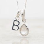 Sterling Silver 'B' Initial Necklace with a tear drop shaped April Birthstone Herkimer Quartz Pendant on a white background.