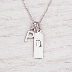 Silver Initial and Capricorn Zodiac Necklace with sterling silver letter P pendant on light wood