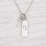 Silver Initial and Capricorn Zodiac Necklace with sterling silver letter T pendant on light wood