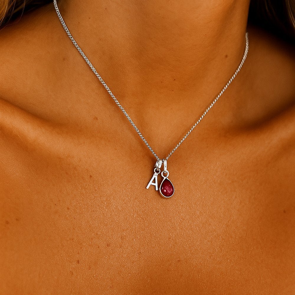 sterling silver initial and july birthstone ruby necklace being worn - indie and harper australia