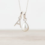 Sterling Silver June birthstone necklace with a pear-shaped natural mother of pearl pendant and letter 'A' charm.